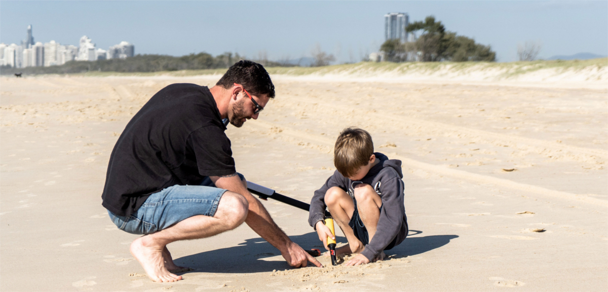 Father and son metal detecting